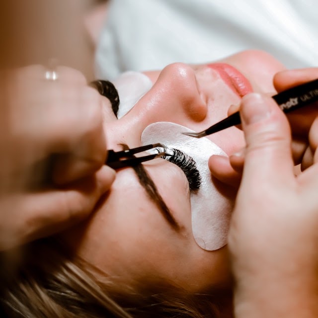 Careful lash extension application at Flirty Studios, with an under-eye patch.